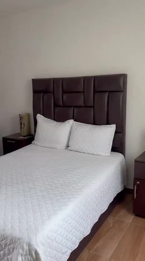 A tour of the rooms: a double bed, a twin room, a television and bathroom doorway, and a wicker lounge corner